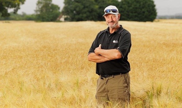 A farmer stood in a field.